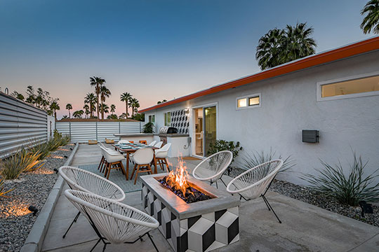 The Summit Palm Springs wrap around backyard with fire pit, dining and cooking area.